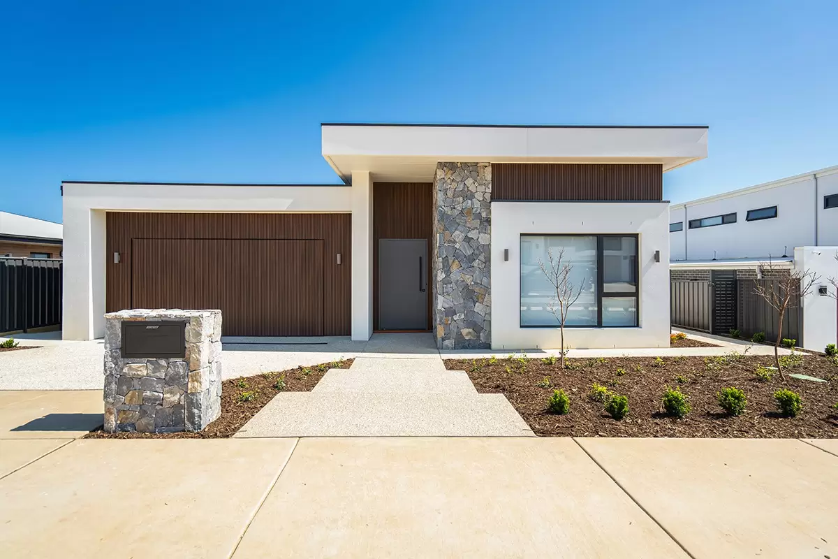 Front yard landscape design with stone feature and structured planting in Whitlam, Canberra